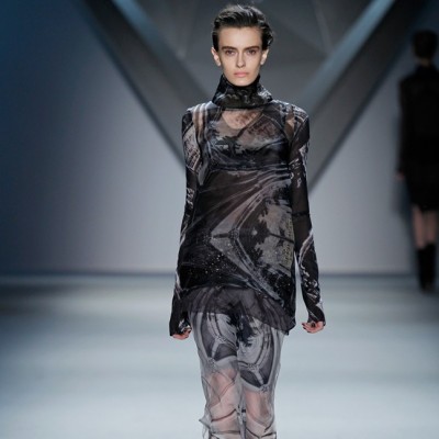 Look 32 | Black vault print silk organza long sleeve high neck top over plum organza racerback tank and black vault print silk chiffon bra over grey vault print silk chiffon floor-length skirt with crystal mesh zip-front peplum over grey ribbed knit bermuda short