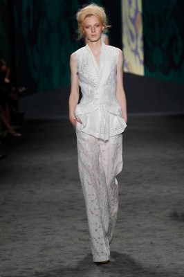 Look 8: White lace jacquard sleeveless cut away jacket with white cotton eyelet sleeveless scarf top with back vent detail over white lace jacquard long pajama trouser | Photography: Dan Lecca