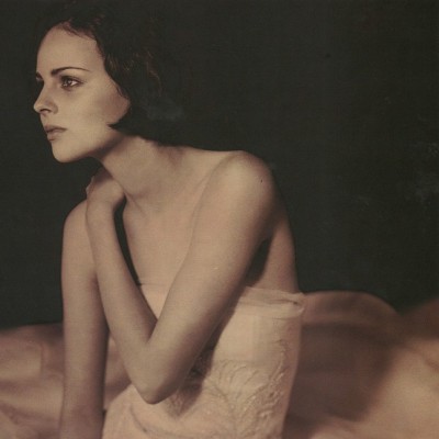 | A strapless wedding gown with an extravagant circular skirt of ivory satin-faced organized veiled in silk tulle.